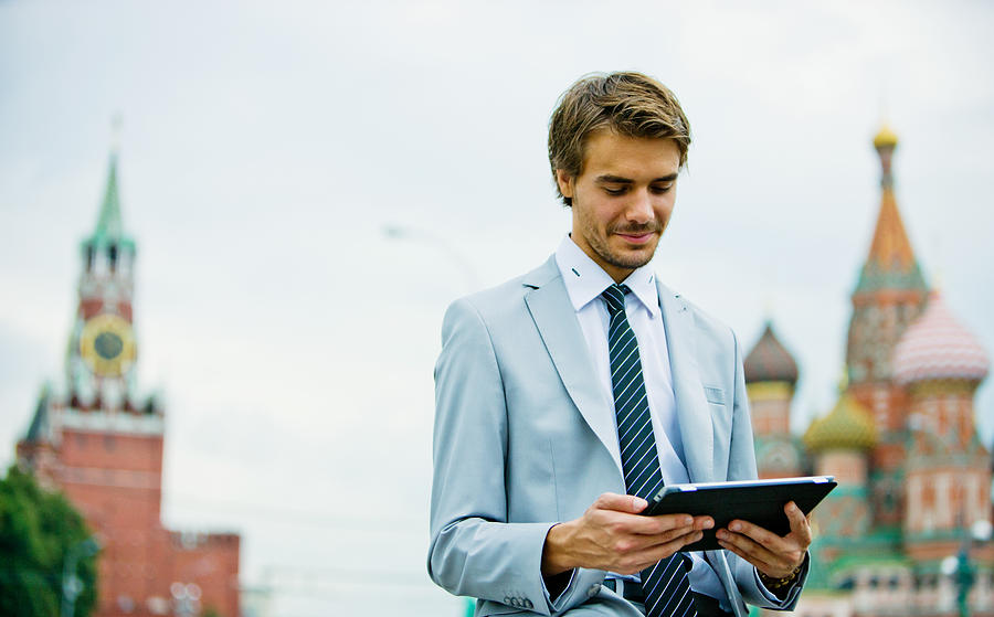 Handsome Young Businessman in Moscow holding Digital Tablet Photograph by Anouchka