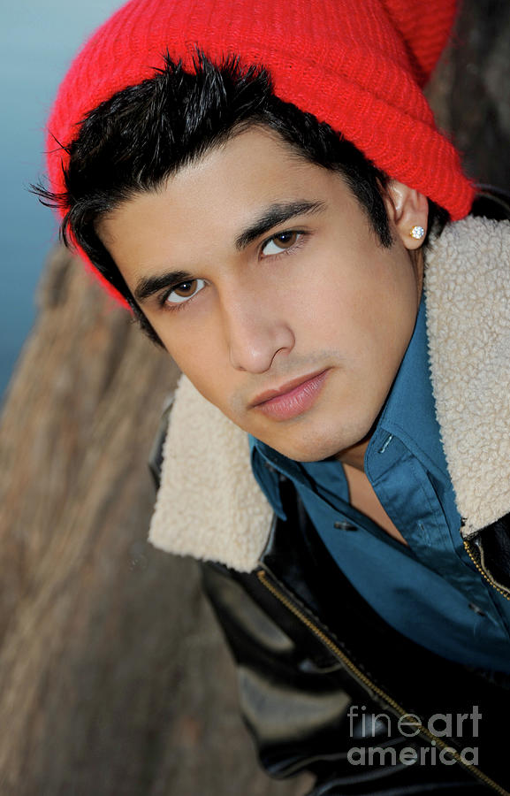 Handsome young hispanic man portrait wearing a red ski cap Photograph by Gunther Allen