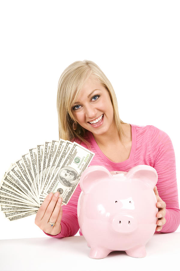 Happy blond woman holding money cash piggybank saving future isolated Photograph by Akurtz