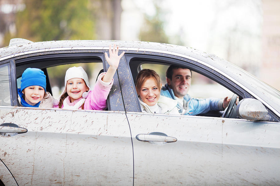 Happy family ina very dirty car. Photograph by Skynesher