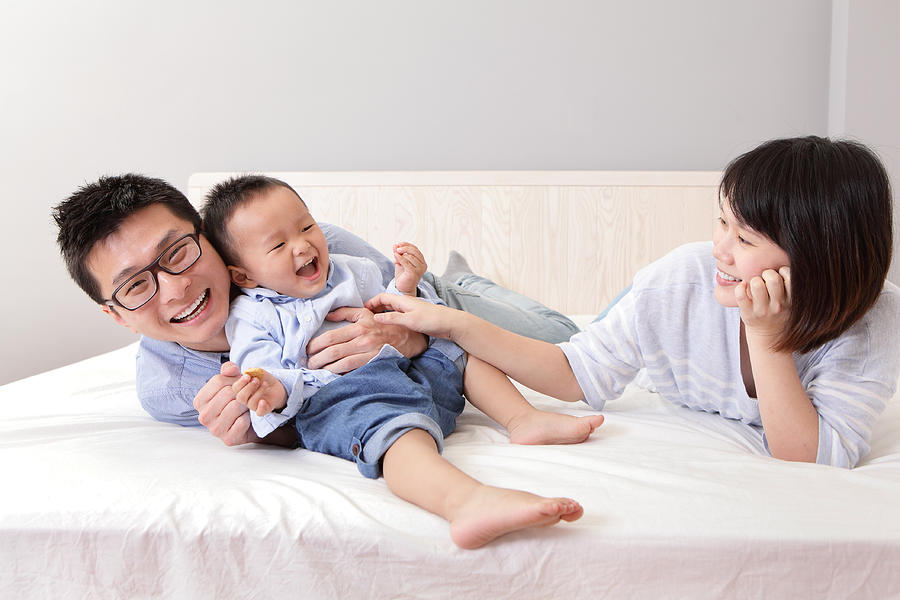 Happy Family Playing On White Bed Photograph by RyanKing999