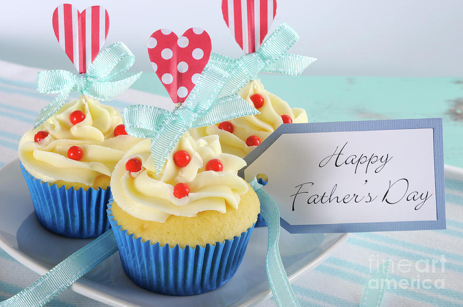 Happy Fathers Day bright and cheery red white and blue decorated cupcakes Photograph by Milleflore Images