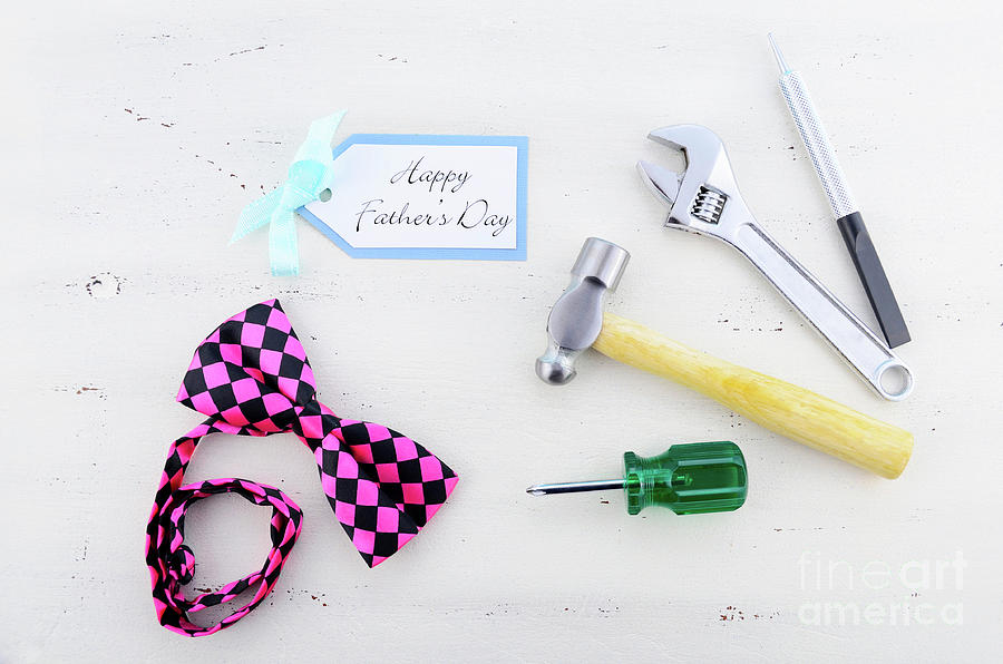 Happy Fathers Day concept with mens tools and pink bow tie.  Photograph by Milleflore Images