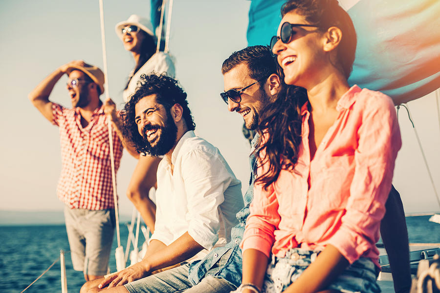 Happy friends on a yacht Photograph by Pixelfit