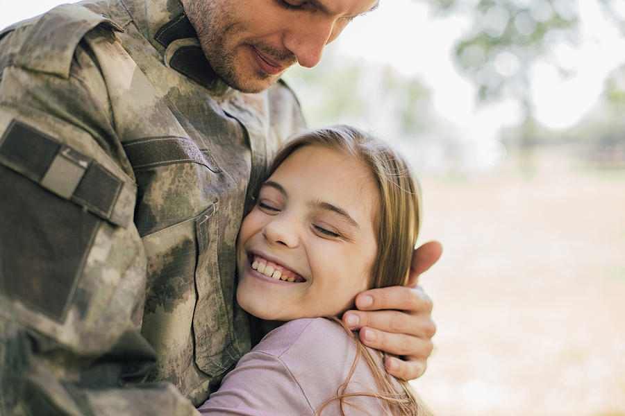 Happy girl hugging a soldier Photograph by RgStudio