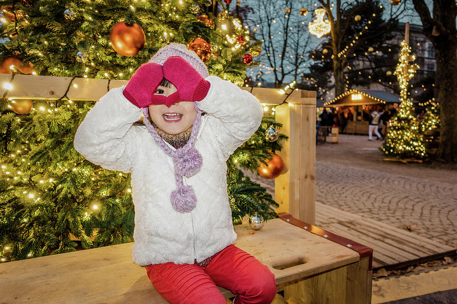 Happy girl in a Christmas market Photograph by Benoit Bruchez