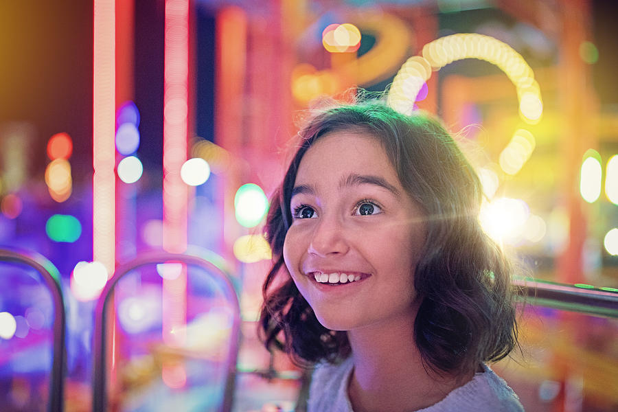Happy girl is smiling on ferris wheel in an amusement park Photograph by Praetorianphoto