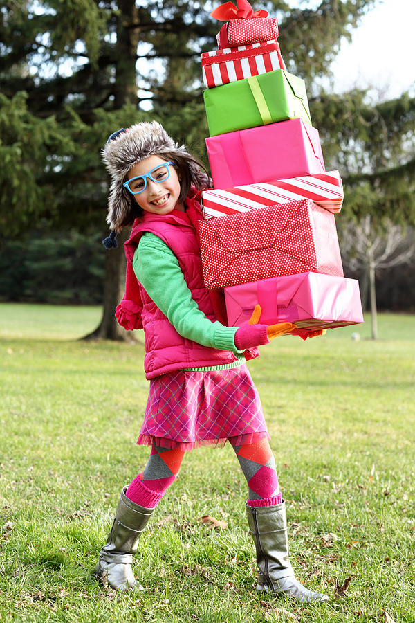 Happy girl with stack of gifts Photograph by Weekend Images Inc.