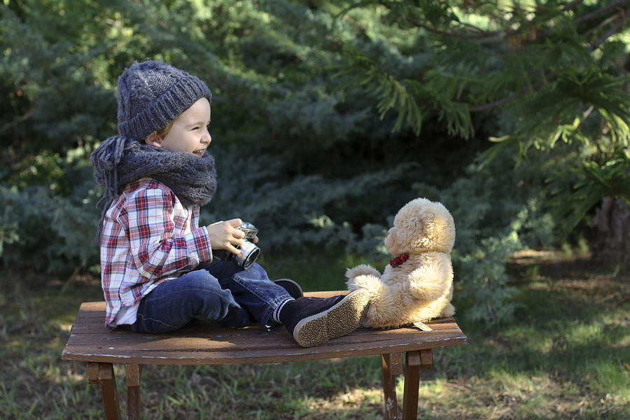 Happy little boy photographing his teddy bear Photograph by Isabel Pavia