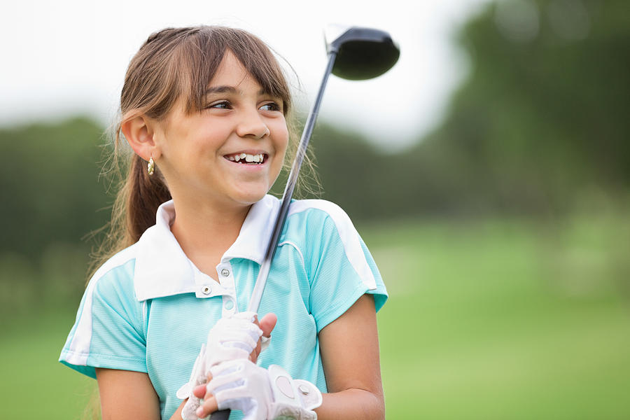 Happy little girl playing golf at country club Photograph by SDI Productions