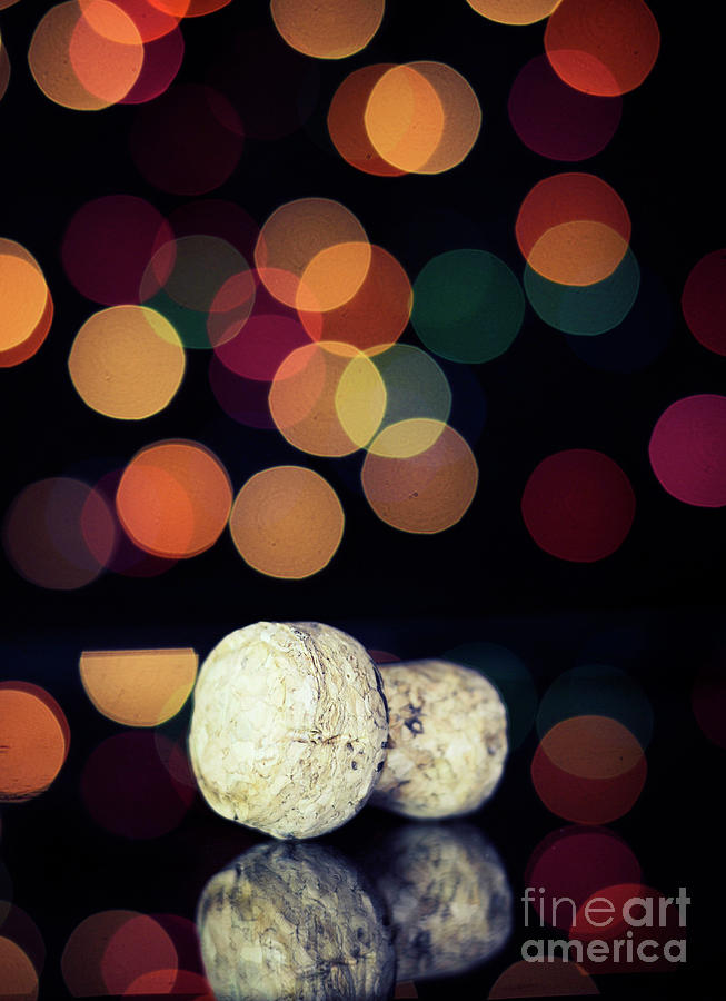 Happy New Year Eve party concept with champagne cork against bokeh lights. Photograph by Milleflore Images