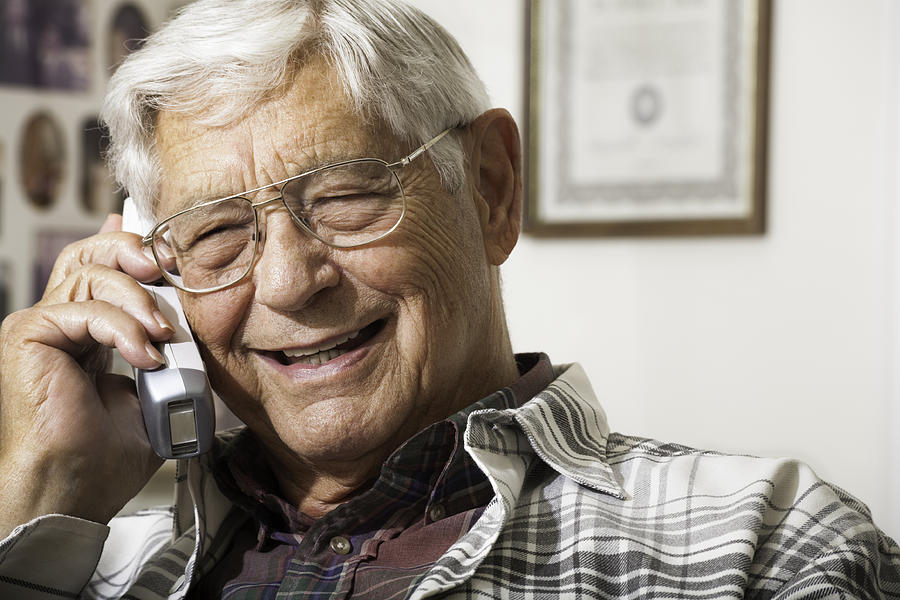 Happy Senior Man Talking On Telephone Photograph by Dszc