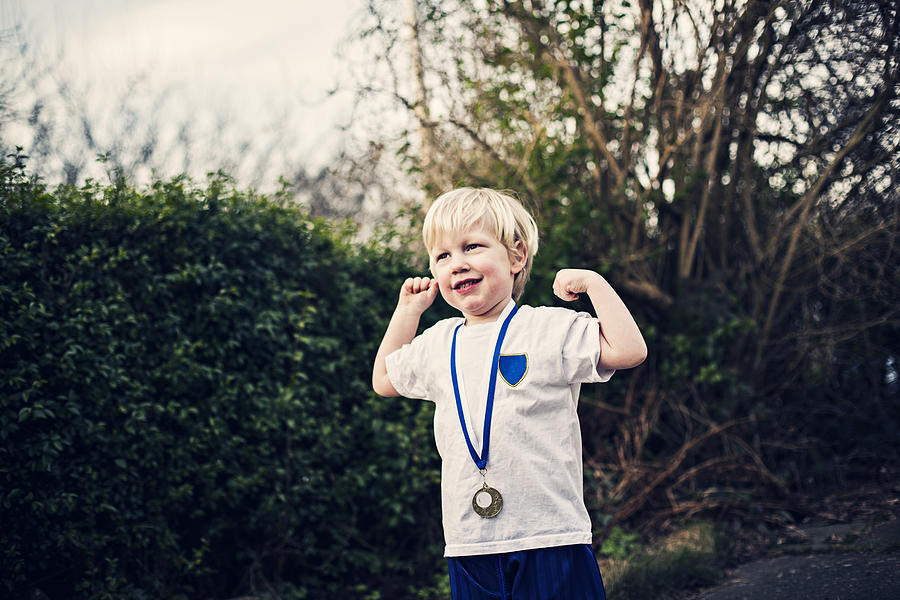 Happy smiling little boy with a medal Photograph by Sally Anscombe