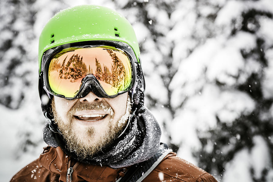 Happy Snowboarder Wearing Helmet and Goggles at The Ski Mountain Photograph by Onfokus