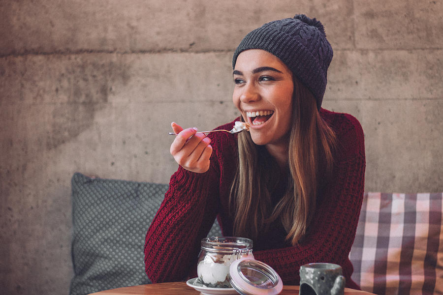 Happy woman eating healthy sweet snack Photograph by Hirurg