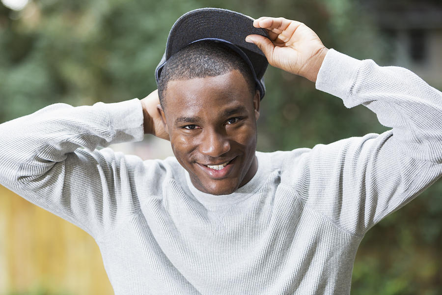Happy young black man wearing gray cap Photograph by Kali9