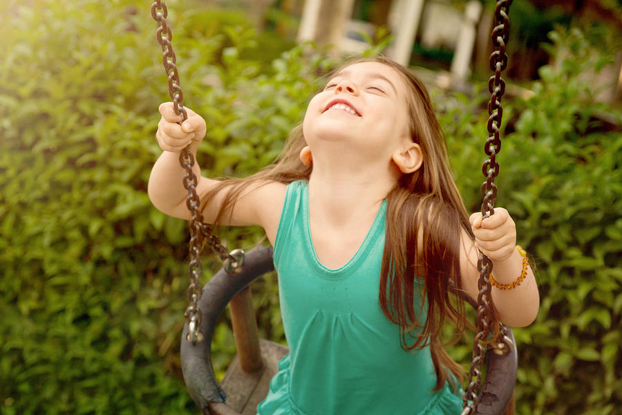 Happy young girl on a swing Photograph by Owl Stories