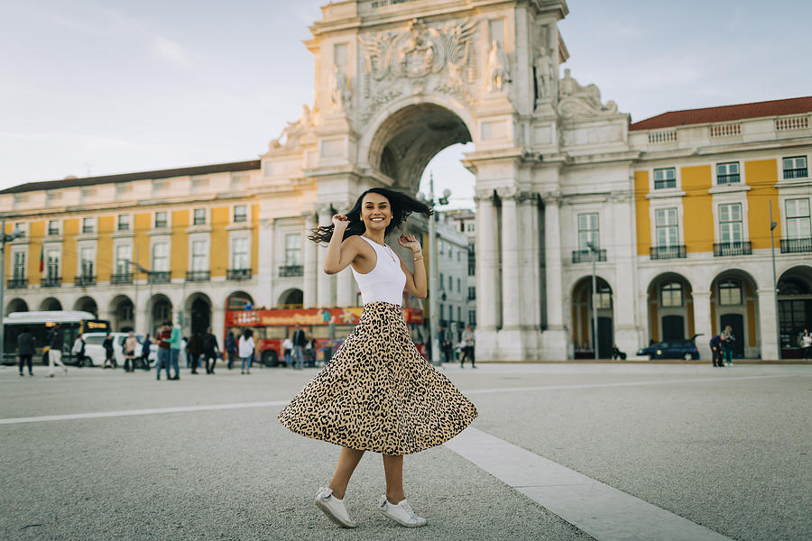 Happy young woman dancing in the city, Lisbon, Portugal Photograph by Westend61