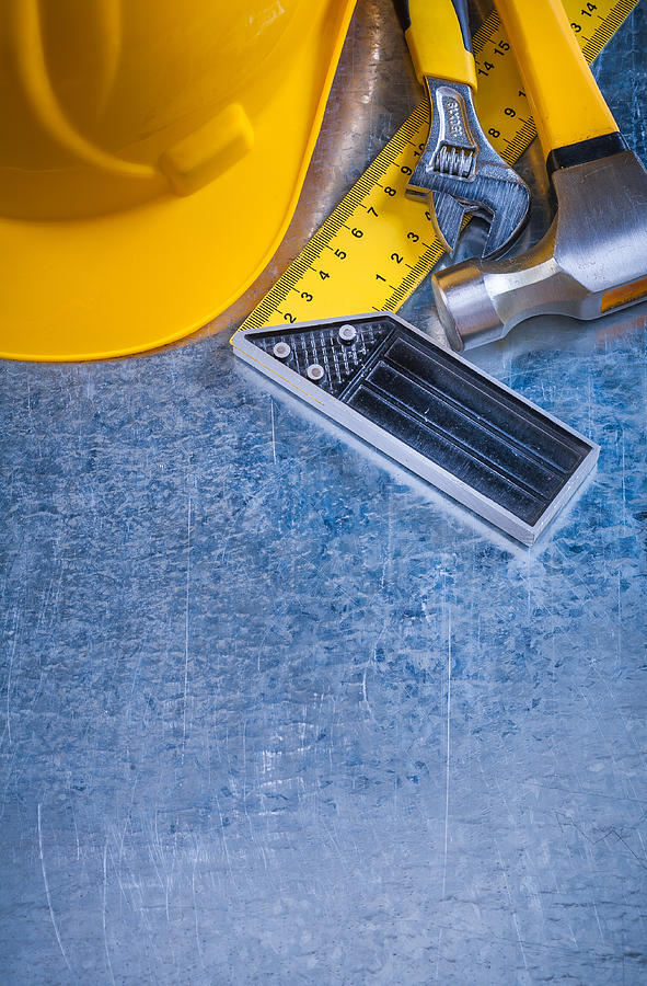 Hard hat claw hammer square ruler and adjustable spanner on Photograph by Mihalec