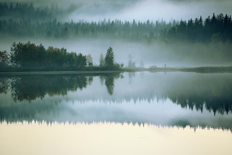 Hazy autumn forest at the shore of a lake is reflected in the sm Photograph by Ulrich Kunst And Bettina Scheidulin