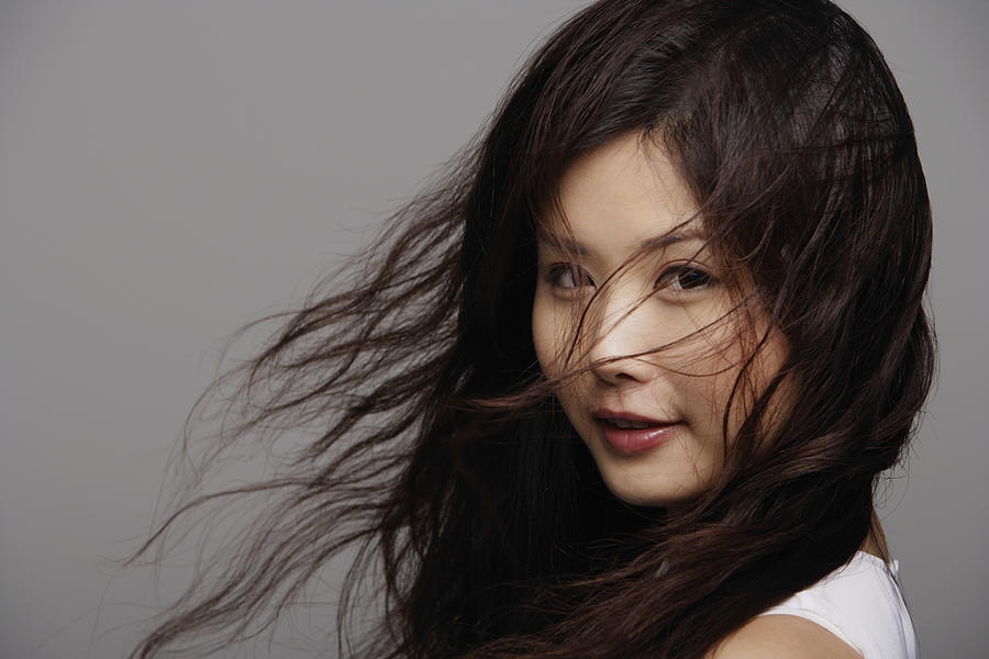 Head shot of Chinese woman with wind blown hair Photograph by Asia Images