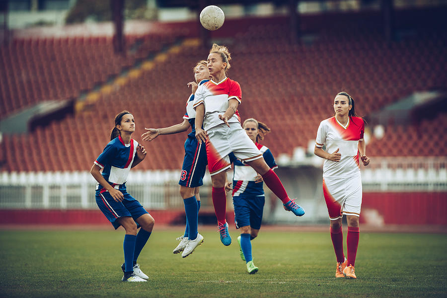 Heading the ball on womans soccer match! Photograph by Skynesher