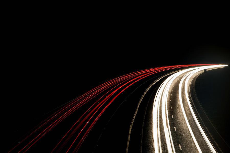 Headlights and tail lights on motorway Photograph by Image Source