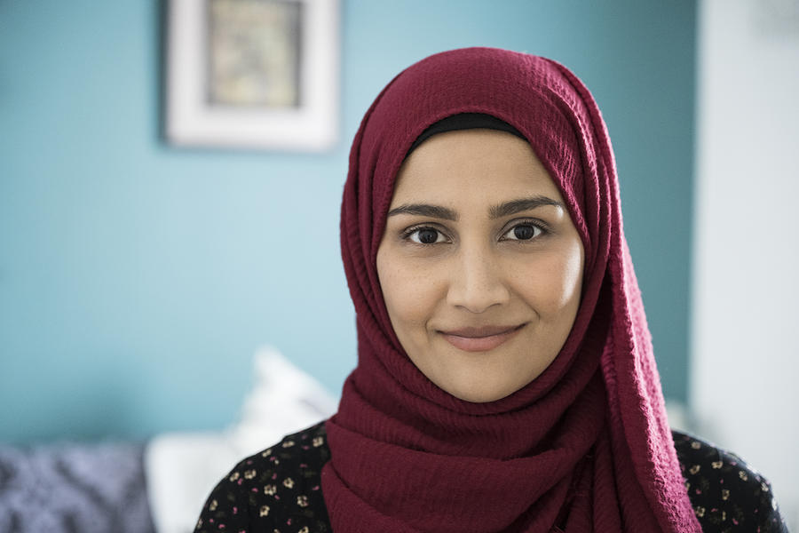 Headshot of mid adult British Asian woman wearing hijab Photograph by JohnnyGreig