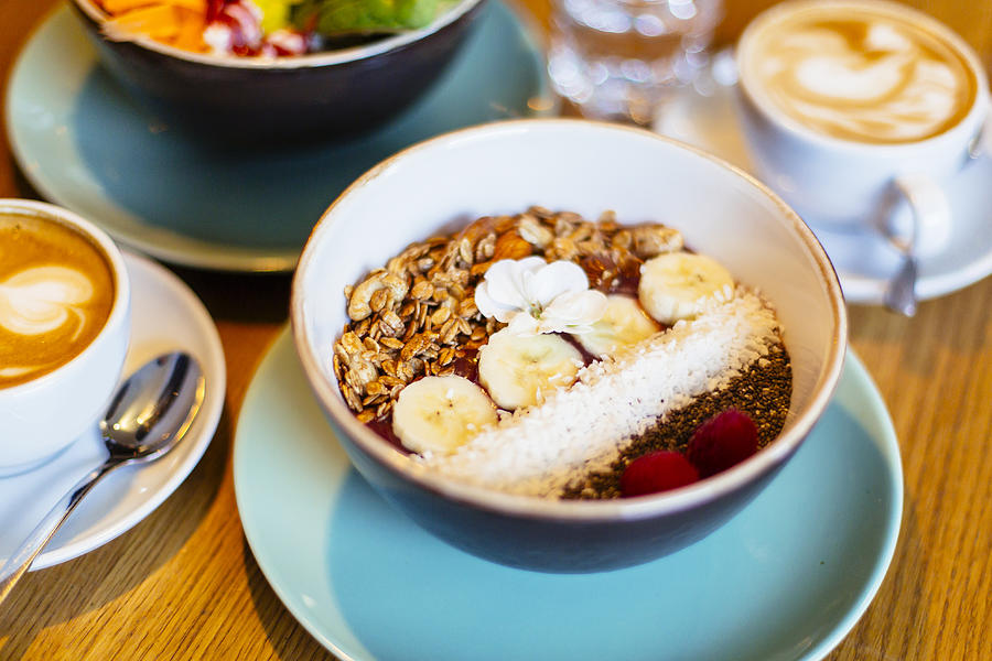 Healthy breakfast in a bowl with acai, fresh fruits, nuts and cereal in it Photograph by Alexander Spatari