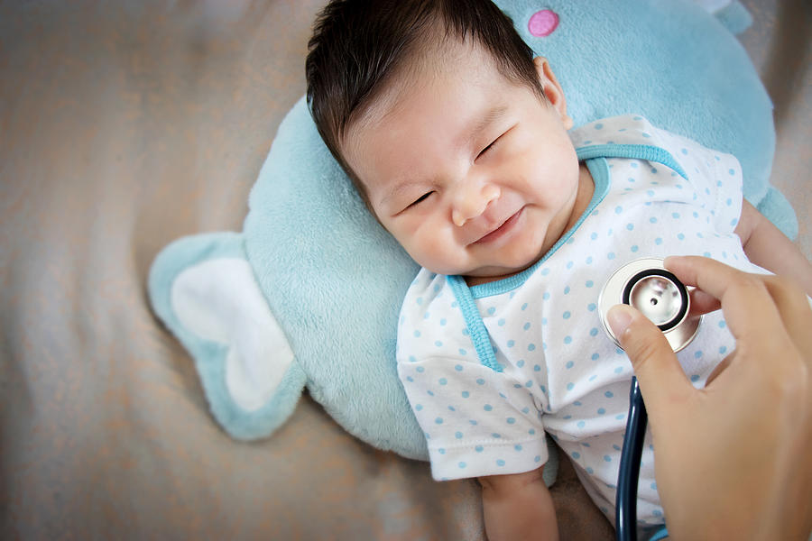 healthy people concept. Asian adorable baby infant laughing with happy face for good health on doctor check up time Photograph by Asiandelight