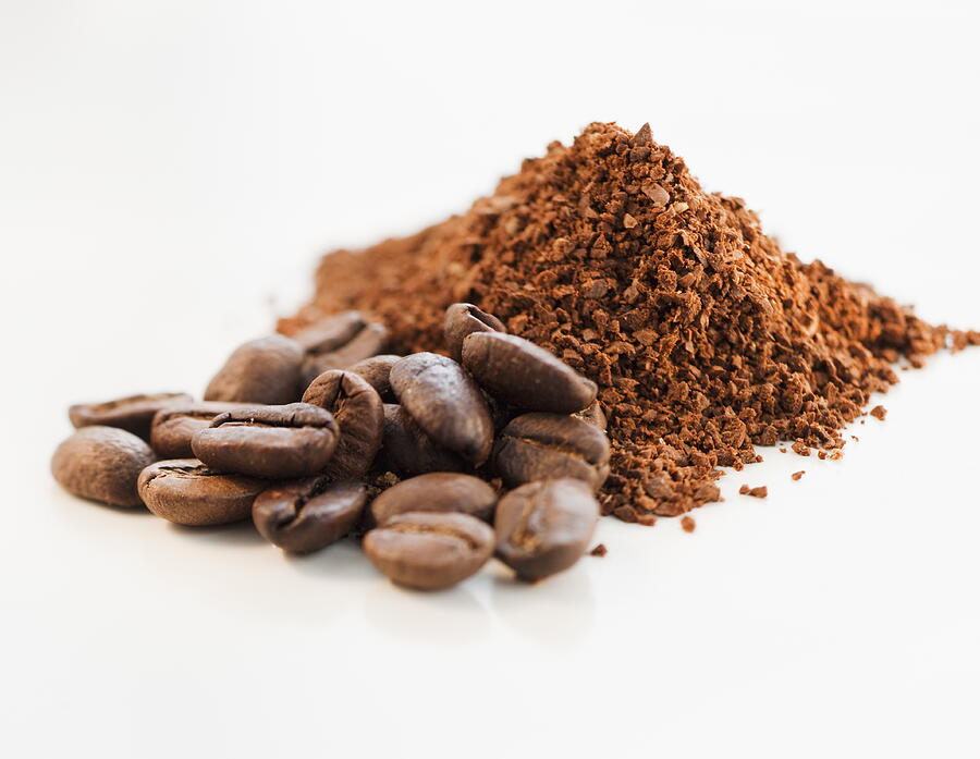 Heap of coffee beans and ground coffee Photograph by Tetra Images