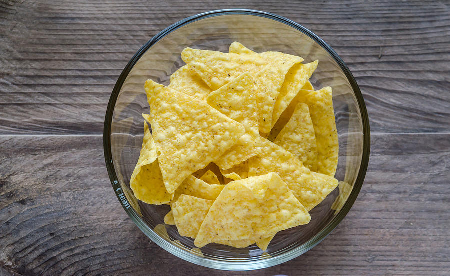 Heap of corn chips in the glass bowl Photograph by AlexPro9500