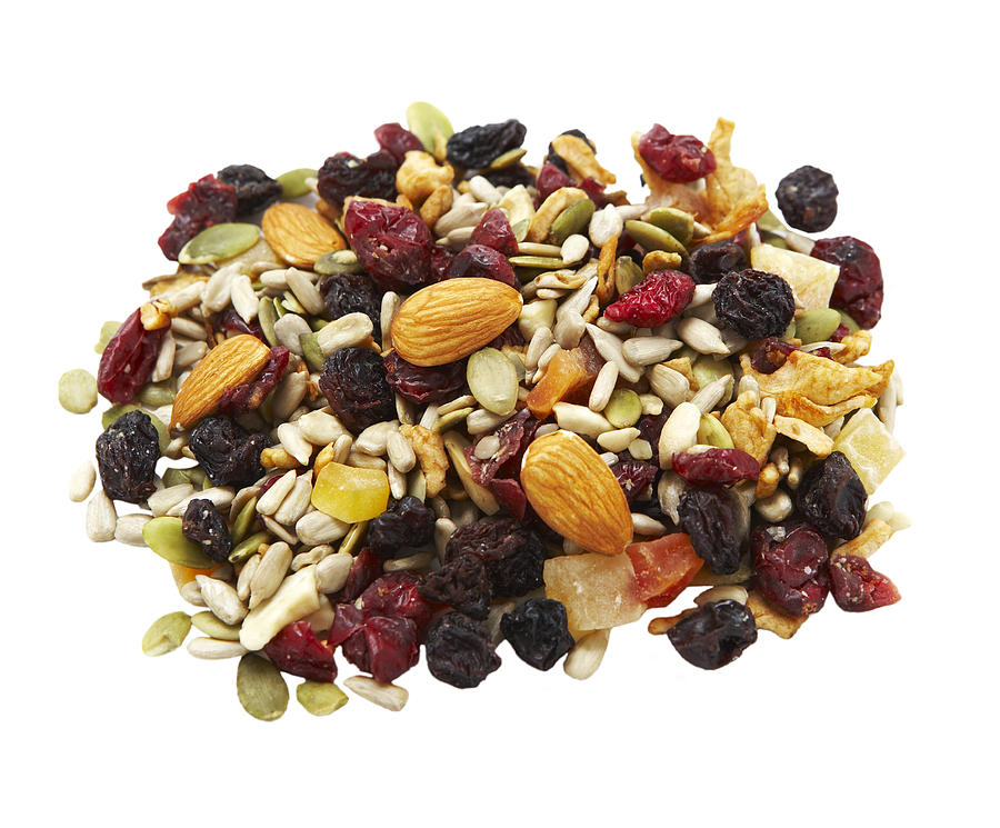 Heap of trail mix on white background Photograph by Thomas Northcut
