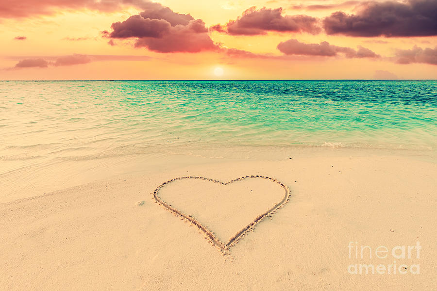 Heart on sand on tropical beach at sunset. Photograph by Michal Bednarek