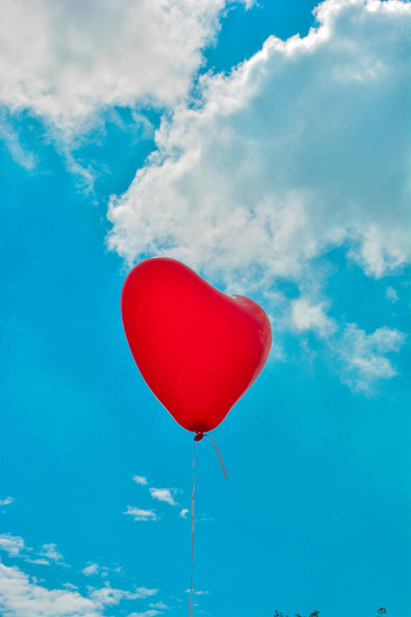 Heart shape balloon flying in sky Photograph by Vladimir Lebedev / FOAP