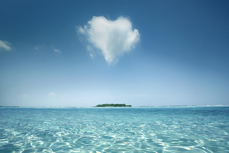 Heart shaped cloud over tropical waters Photograph by Tom Merton