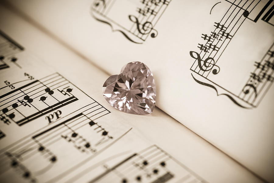 Heart shaped cubic zirconia & music sheet Photograph by Lifeispixels