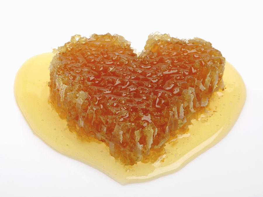 Heart shaped honeycomb in pool of honey Photograph by Geir Pettersen