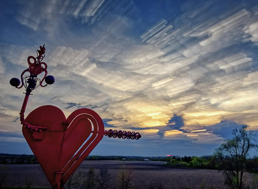 Here be Dragons - Evermore heart ray gun sculpture shooting cloud dragon near Stoughton WI Photograph by Peter Herman