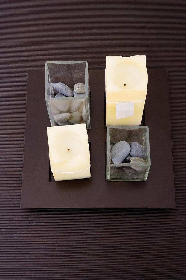 High angle view of candles and pebbles on a table Photograph by Glowimages