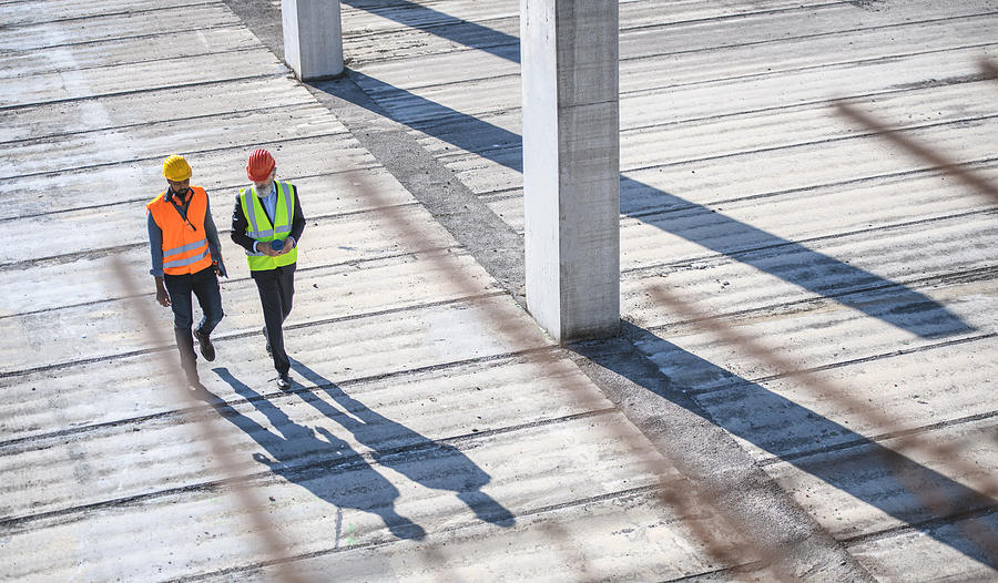 High Angle View of Construction Site Colleagues Photograph by AzmanL