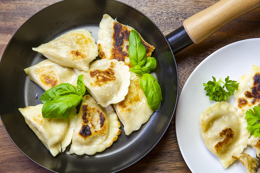 High Angle View Of Dumplings On  frying pan and white Plate (Polish pierogies) Photograph by Mikroman6