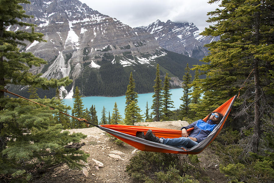 High angle view of hiker resting in hammock against Peyto Lake and mountains at Banff National Park Photograph by Cavan Images