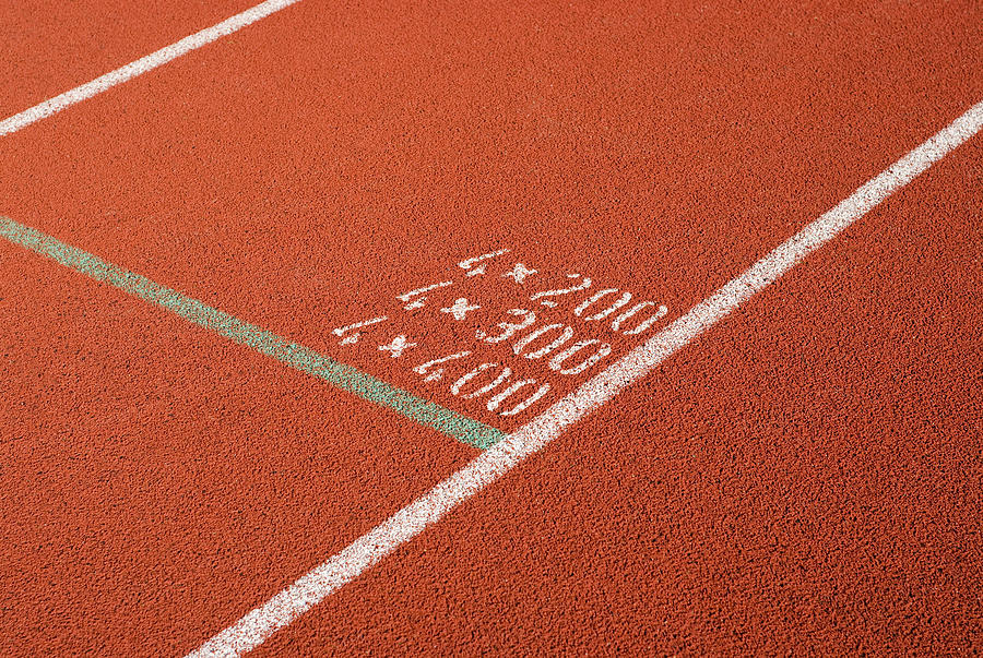 High angle view of numbers painted on a running track Photograph by Glowimages
