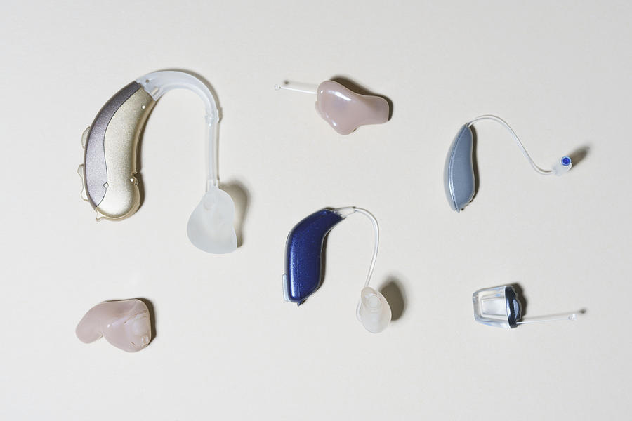High angle view of various hearing aids arranged on table Photograph by Halfdark