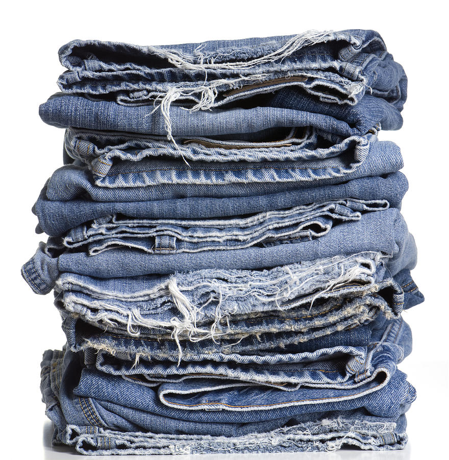 High Resolution Stack of Frayed Denim Jeans Photograph by Smartstock