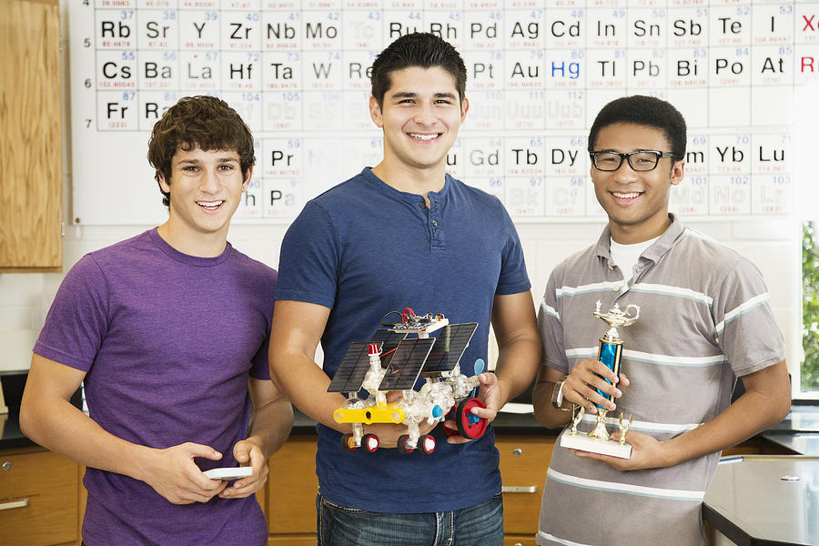 High school students holding solar powered machine and trophy Photograph by Jon Feingersh Photography Inc
