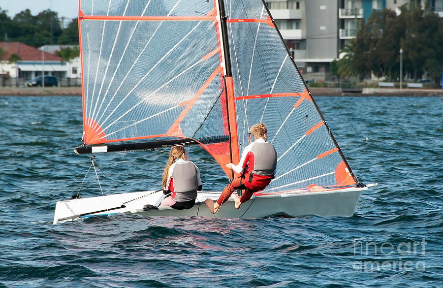 High school students Sailing small sailboat in competition on a  Photograph by Geoff Childs