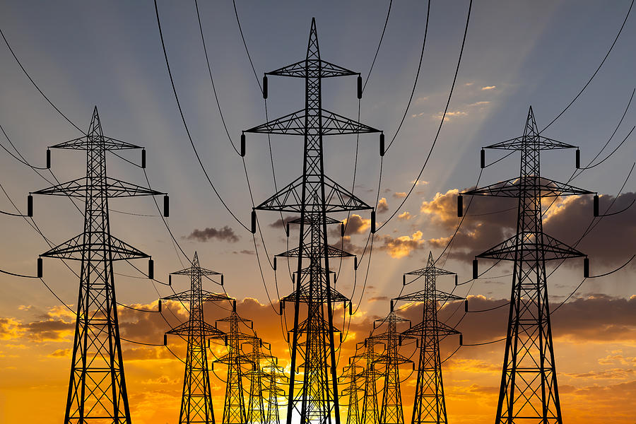 High voltage towers at sunset background. Power lines against the sky Photograph by Anton Petrus