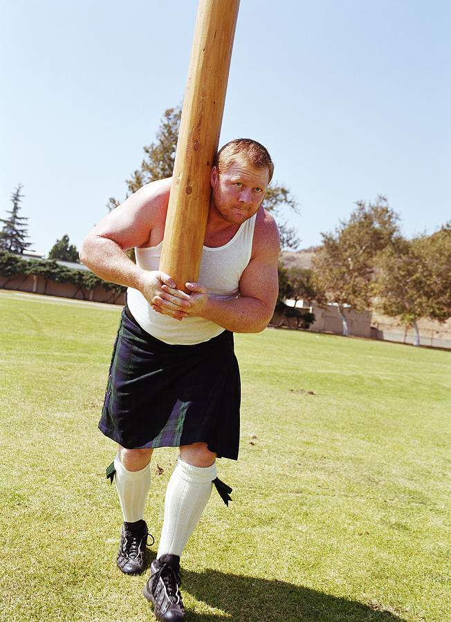 Highland Games, competitor tossing caber Photograph by Mike Powell